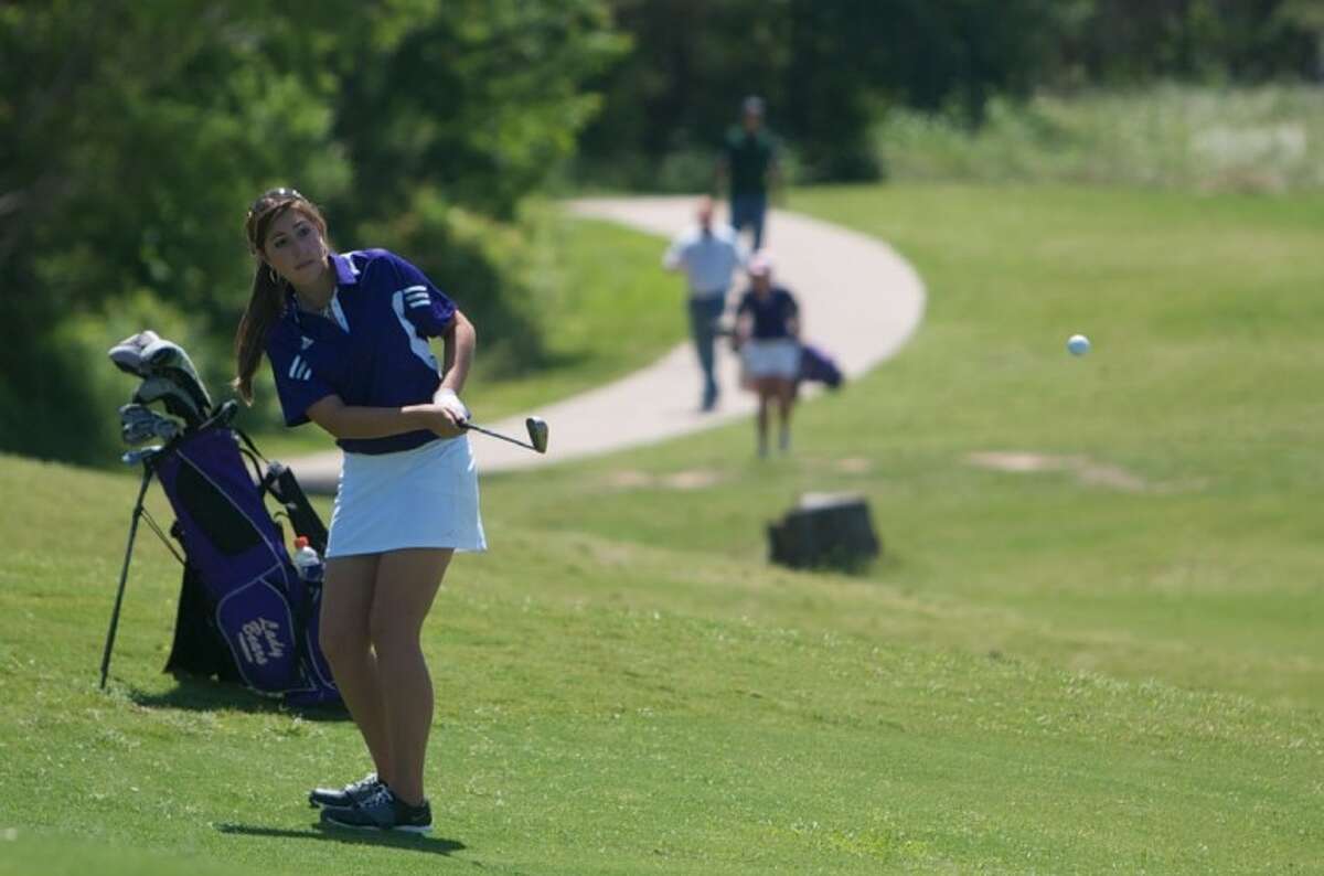 Montgomery's Abbey Toohey hits out of the bunker on the 18th hole during the final round of play in Tuesday's Region III-4A Girls Golf tournament at Raven Nest golf course in Huntsville.