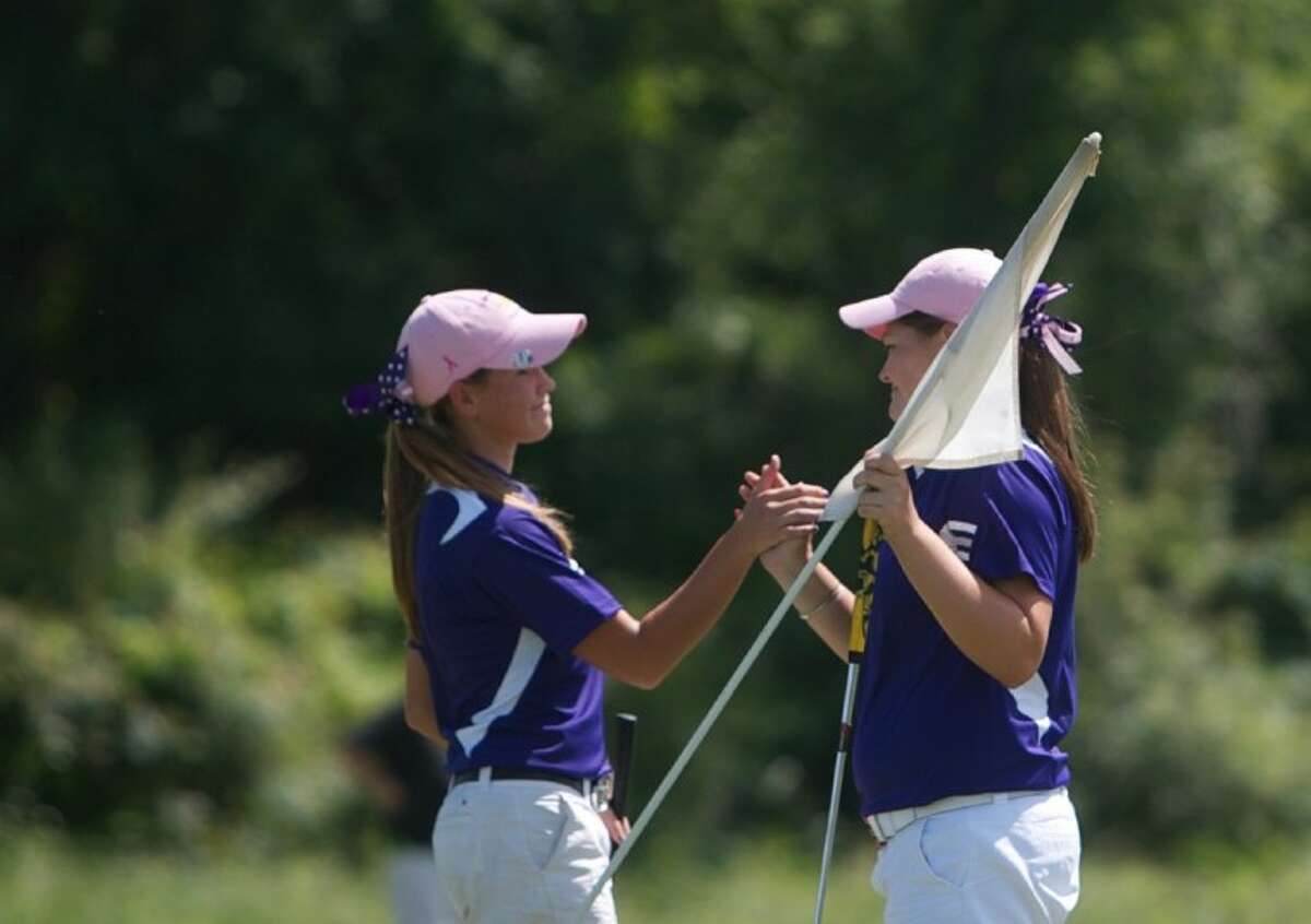 Montgomery's Abbey Bradley, left, and Kallie Gonzalez celebrate following the final round of play in Tuesday's Region III-4A Girls Golf tournament at Raven Nest golf course in Huntsville.