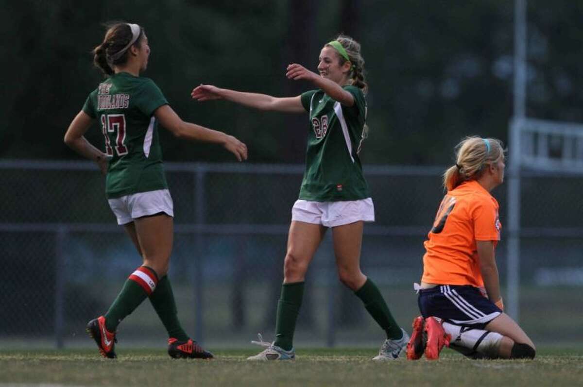The Woodlands forward Kaleigh Olmsted, right, was named the District 14-5A soccer MVP. Here she celebrates a goal with teammate Carmen Webster, a first-team selection on the team.