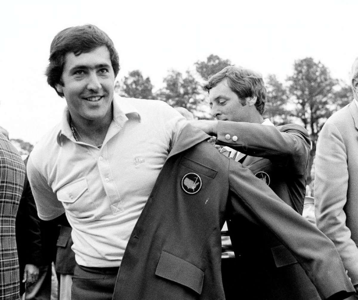 Seve Ballesteros, left, is helped with his Masters green jacket by the previous year’s winner, Fuzzy Zoeller, after winning the 1980 Masters in Augusta, Ga.
