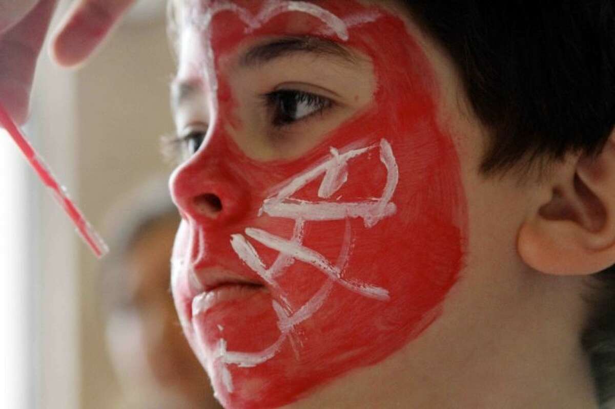 Tristan Flower gets his faced painted like Spiderman during Bunny Fest at McCullough Junior High Saturday. Children played games, decorated cookies and got their face painted at the annual event.