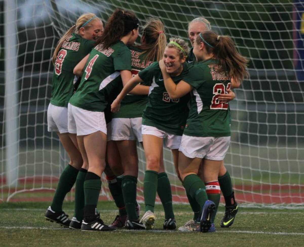 The Woodlands forward Kaleigh Olmsted, center, gets mobbed by teammates after scoring the first of her two goals in the second half of a Region II-5A bi-district playoff match against Klein Collins on Friday at Klein Collins High School. To view or purchase this photo and others like it, visit HCNpics.com.