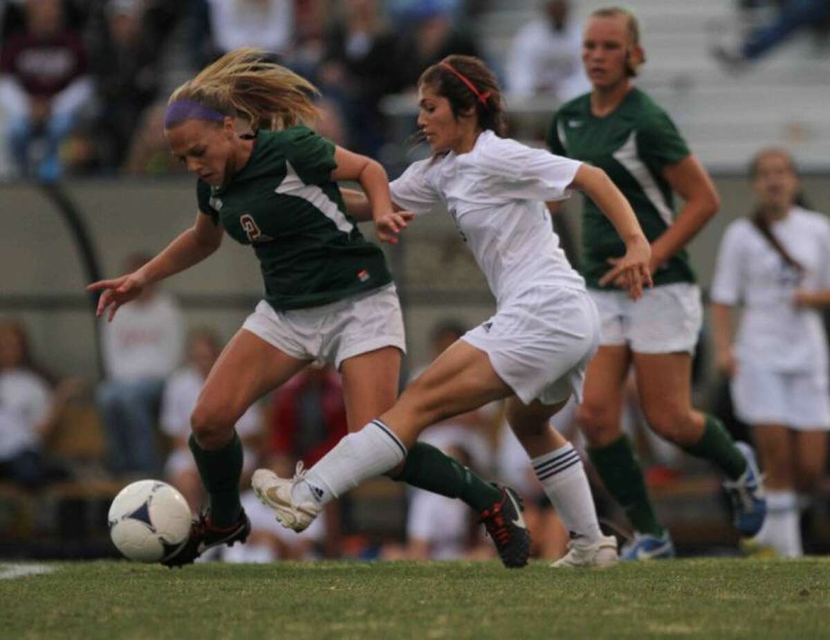 The Woodlands midfielder Kelly Barbalias fights to keep possession of the ball during a Region II-5A bi-district playoff match Friday.