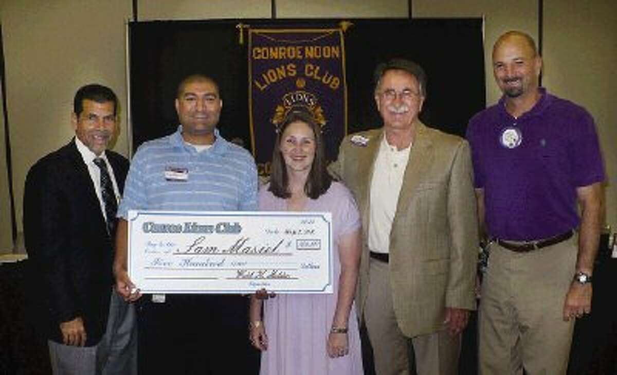Utility Billing Manager Sam Masiel holds the $500 check he received from the Conroe Noon Lions Club as the city of Conroe’s 2011 Employee of the year. Also in the photo are (from left) City Administrator Paul Virgadamo, Masiel’s wife Megan, Conroe Mayor Webb Melder and City Finance Director Steve Williams.