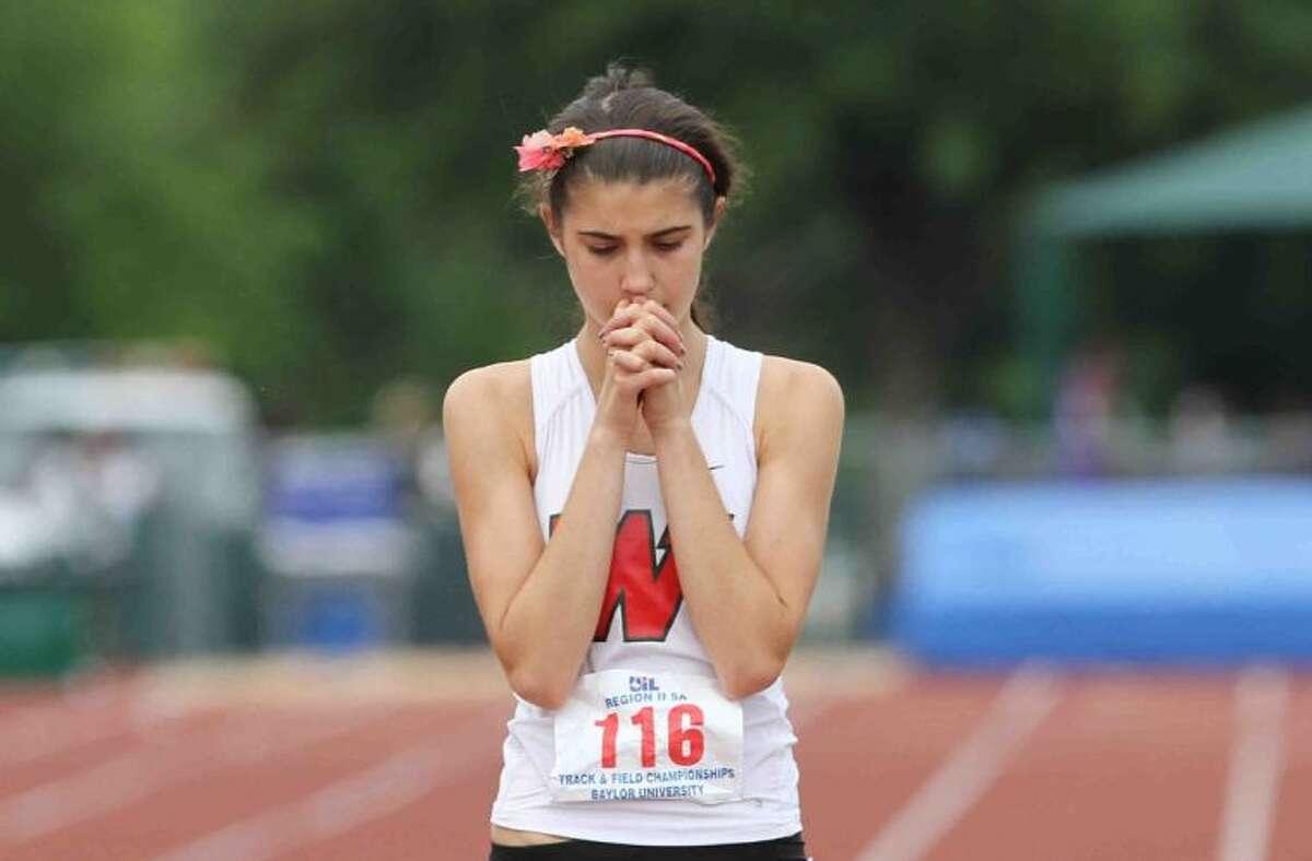 The Woodlands’ Katie Willard prays before the start of the 800-meter run in the Region II-5A Track and Field Championships on Saturday in Waco.