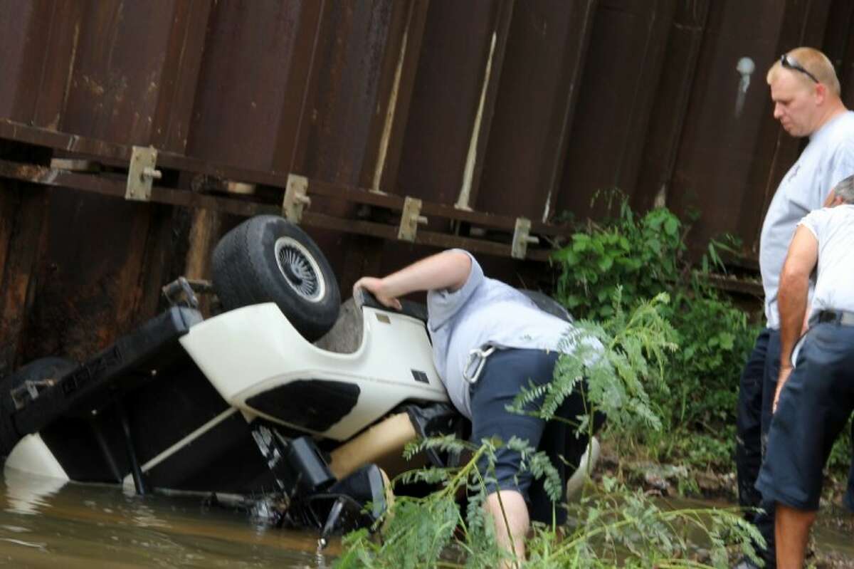 Father, son crash golf cart off 30-foot high bridge