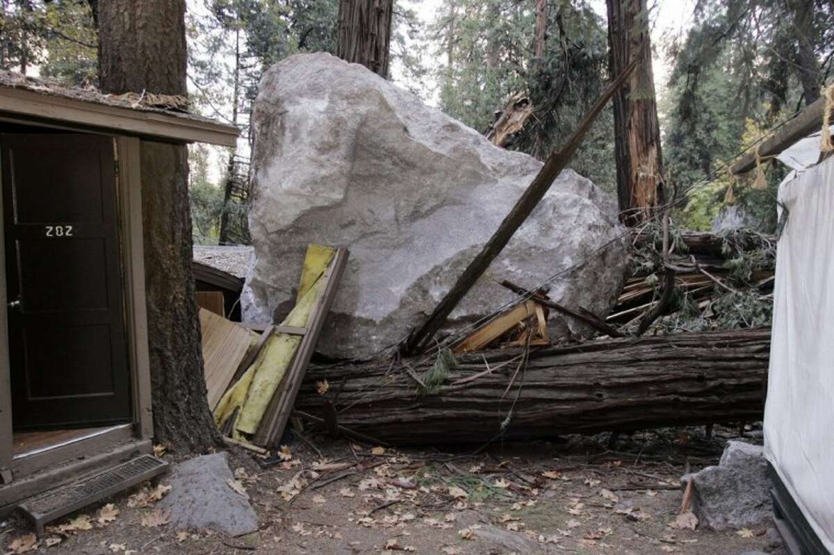 In this Oct. 20, 2008 file photo, a boulder sits atop debris after it fell in Curry Village in Yosemite National Park, Calif. Falling boulders are the single biggest force shaping Yosemite Valley, one of the most popular tourist destinations in the national park system. Now swaths of some popular haunts are closing for good after geologists confirmed that unsuspecting tourists and employees are being lodged in harm’s way.