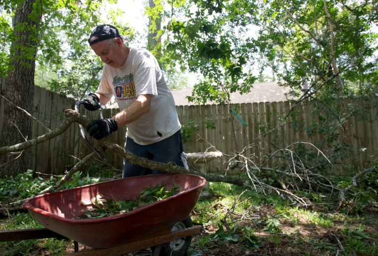 County Residents Removing Fallen Trees Limbs After Storm