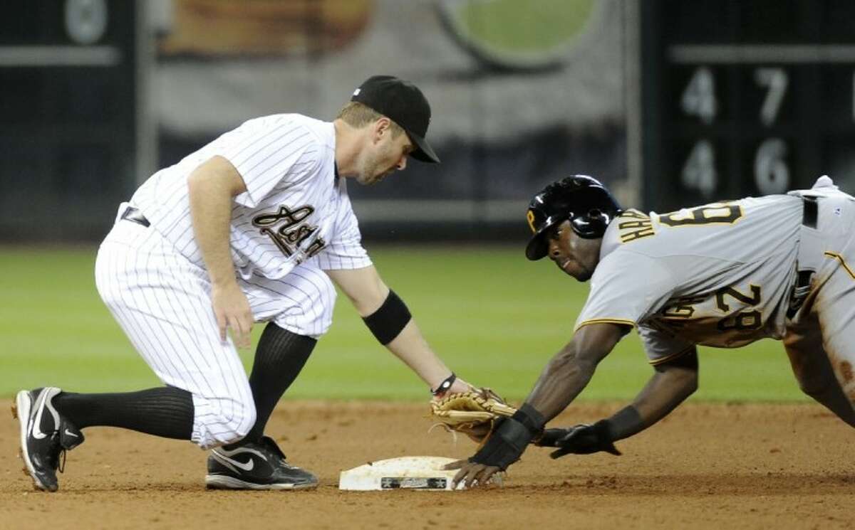 The Pittsburgh Pirates' Josh Harrison gets his hand on second base for a steal as Houston Astros second baseman Jeff Keppinger reaches to tag him in the sixth inning Friday in Houston.
