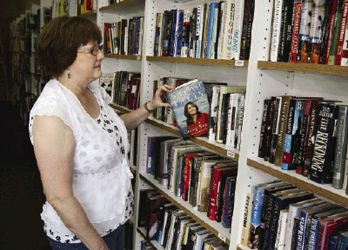 Conroe resident Kay Hayter looks for books on the shelves of A Novel Idea -- a new and used bookstore that has announced their closing.
