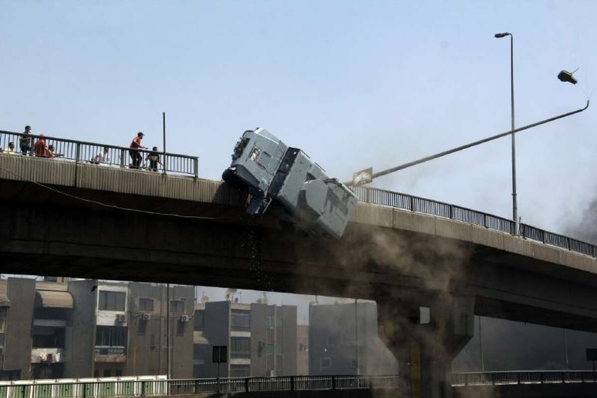 A police vehicle is pushed off of the 6th of October bridge by protesters close to the largest sit-in by supporters of ousted Islamist President Mohammed Morsi in the eastern Nasr City district of Cairo, Egypt, Wednesday.