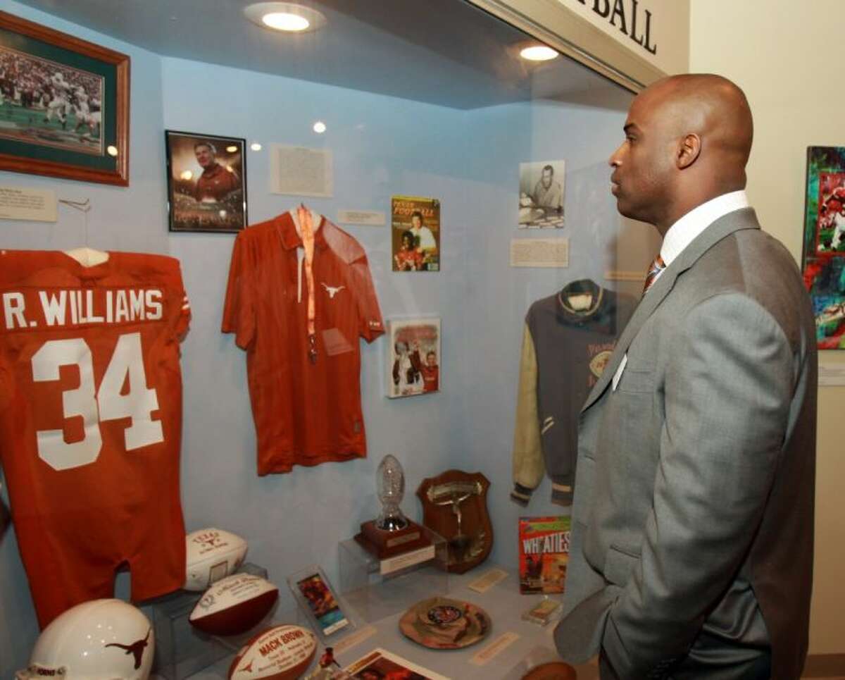 Former Texas football player and Heisman Trophy winner Ricky Williams looks at his display case at a reception before the Texas Sports Hall of Fame induction ceremony on Feb. 18 in Waco.