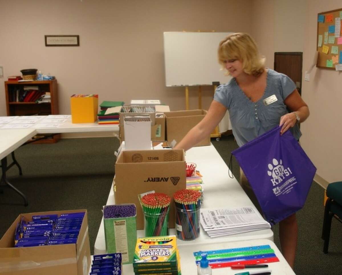 Stacy Schlabach helps assemble a bag full of school supplies for children Saturday morning at the First United Methodist Church of Willis’ annual School Supply Giveaway.