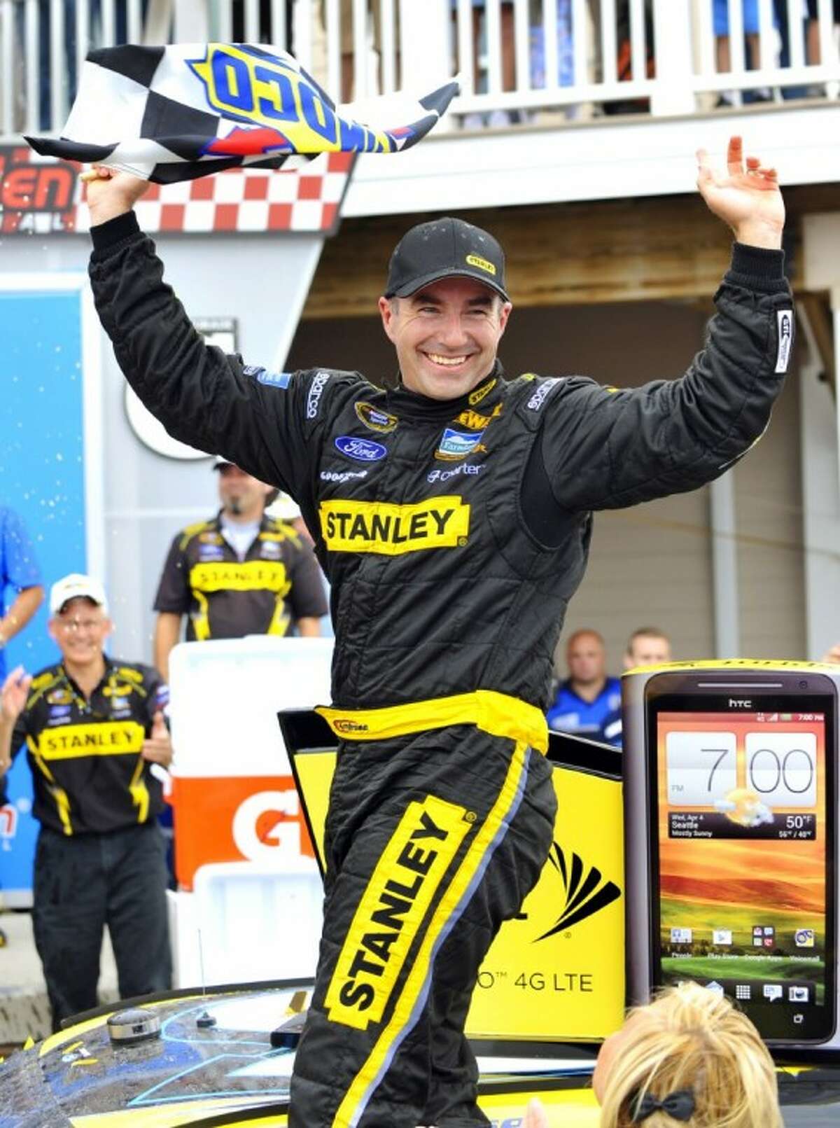 AP photo Marcos Ambrose stands on his car in victory lane as he celebrates his win at the NASCAR Sprint Cup Series auto race at Watkins Glen International.