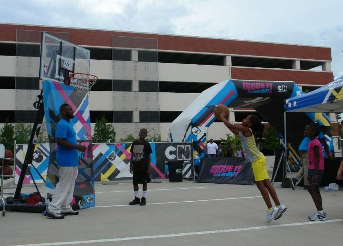 A youngster shoots some hoops Sunday afternoon at Cartoon Network's "Move It Movement" Tour at Sam Houston State University The Woodlands Center. The NBA Hoop Troop was one of several activities designed to promote fitness and nutrition for children while also offering a chance for parents to meet with SHSU representatives regarding education opportunities.