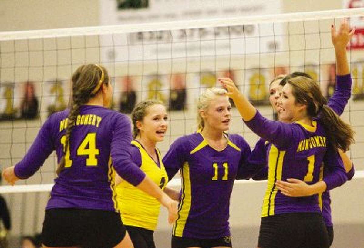 Montgomery players celebrate a point during Tuesday night's non-district game against Conroe.
