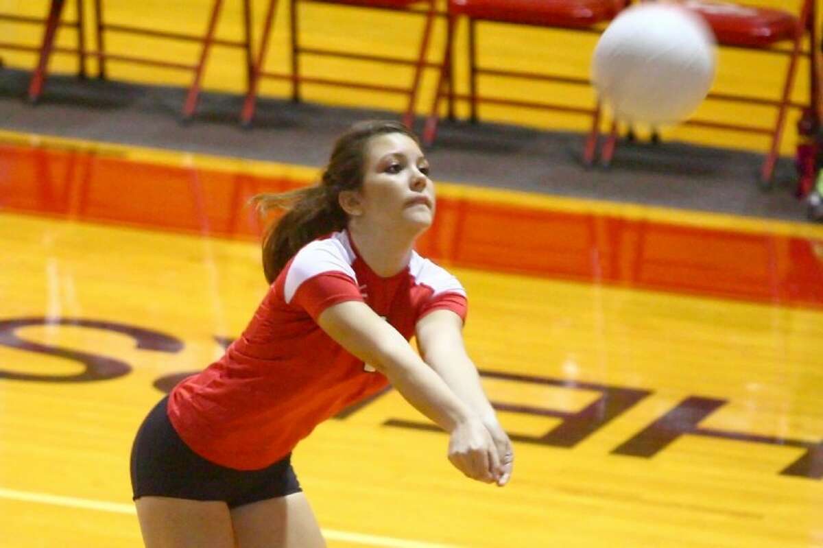 Catherine Pool goes for a dig during the match against Klein Forest Tuesday at Caney Creek High School.