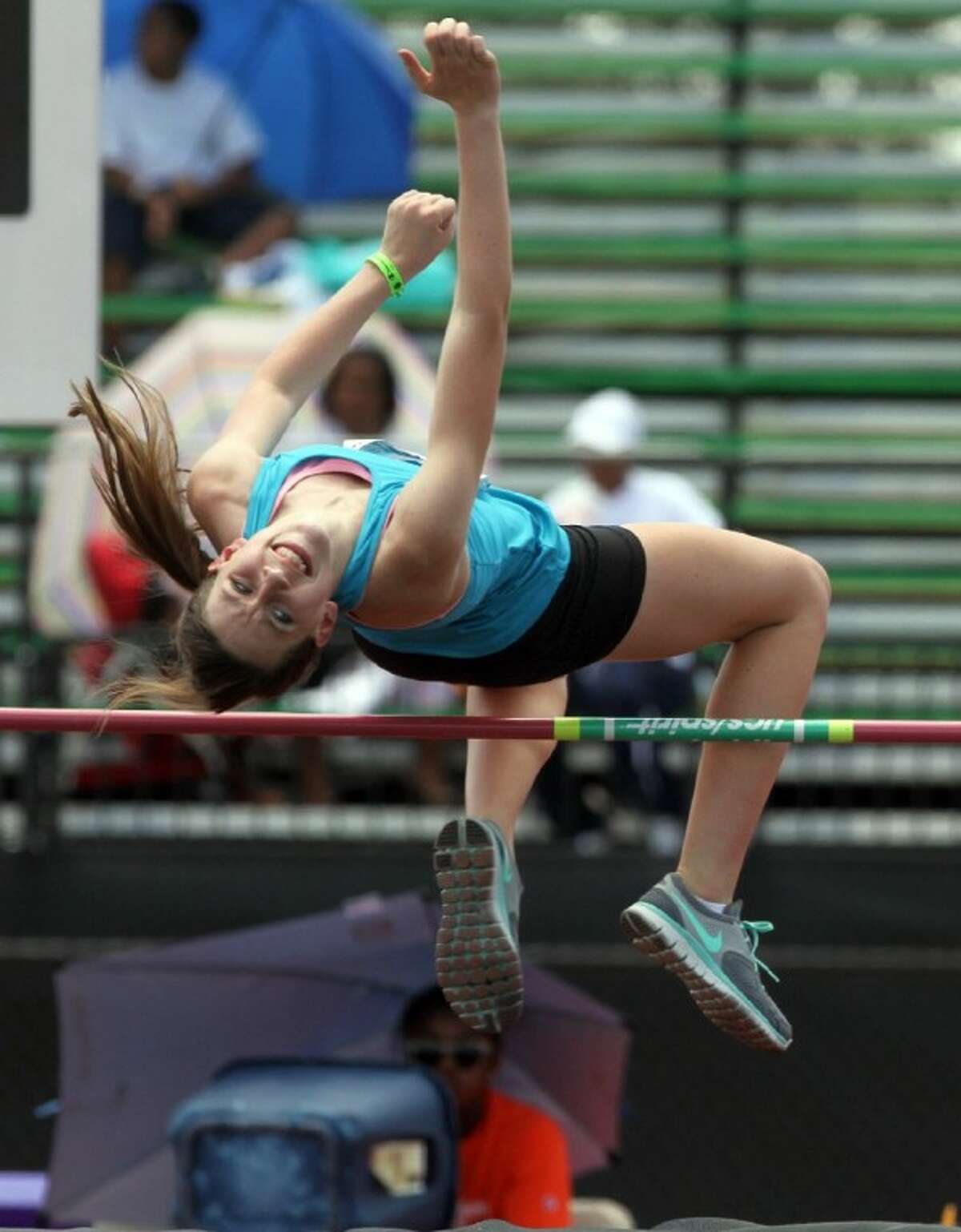 Darcy Sanford clears the bar in the sub-youth girls high jump last Tuesday during the AAU Junior Olympic Games at Turner Stadium in Humble.