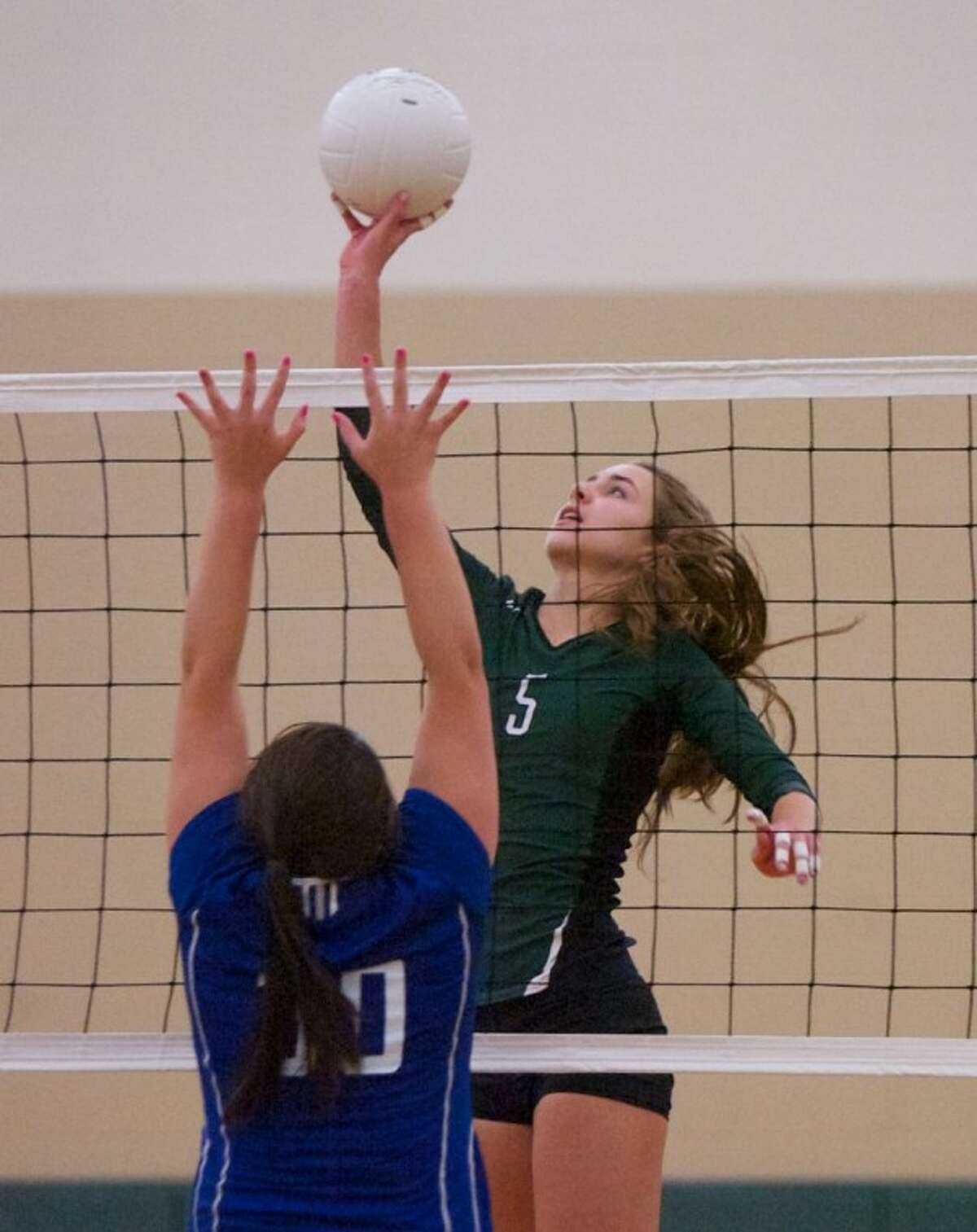 The John Cooper School’s Margaret Connett goes up for a spike during Wednesday night’s match against Lutheran North in The Woodlands.