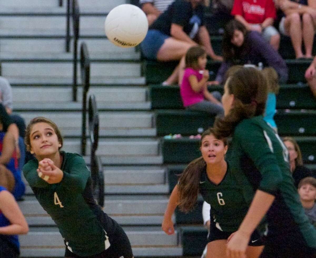 The John Cooper School’s Christina Gooch digs the ball during Wednesday night’s match against Lutheran North in The Woodlands.