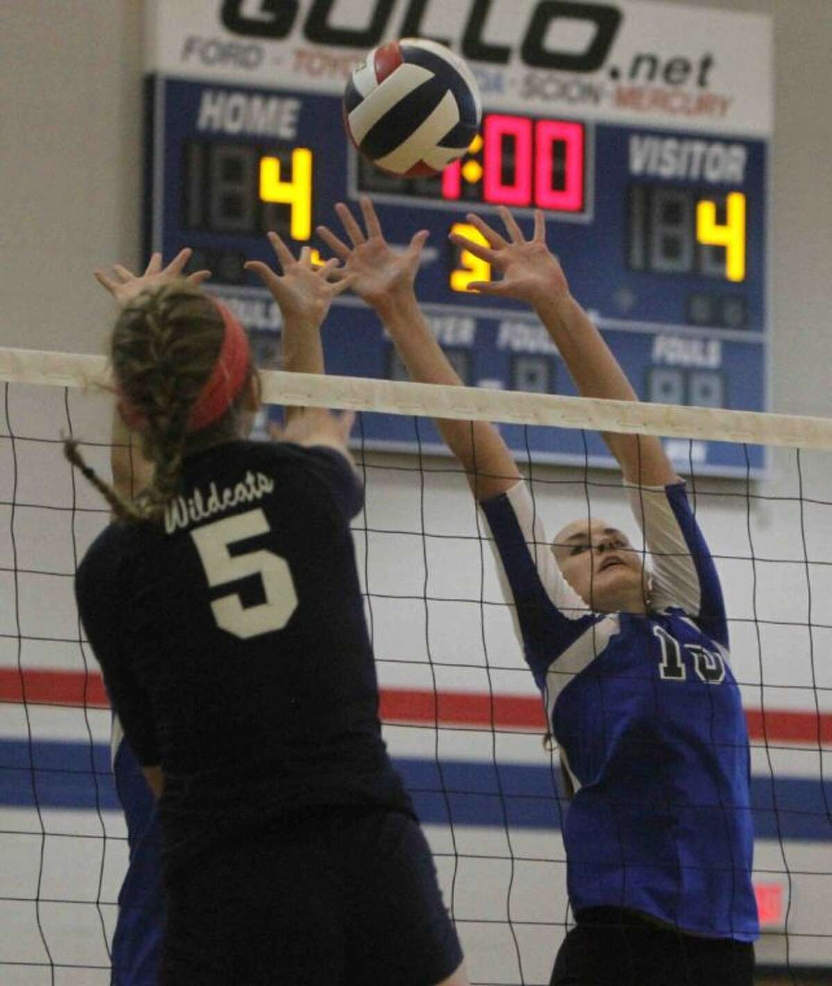 Oak Ridge’s Victoria Harris goes up to block a shot by Tomball Memorial’s Amanda Coursey during a volleyball game at Oak Ridge High School Tuesday. Oak Ridge defeated Tomball Memorial in four sets. Go to HCNPics.com to view and purchase this photo, and others like it.