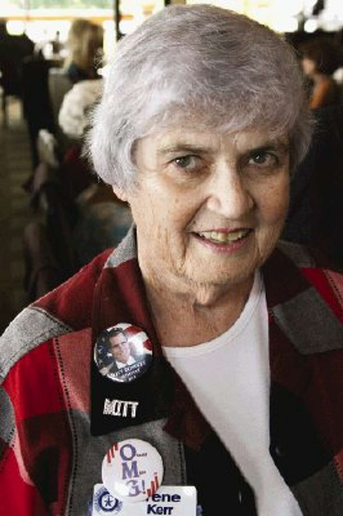 Irene Kerr, deputy president of the Texas Federation of Republican Women, shows off her campaign buttons and election jewelry in support of presidential candidate Mitt Romney.