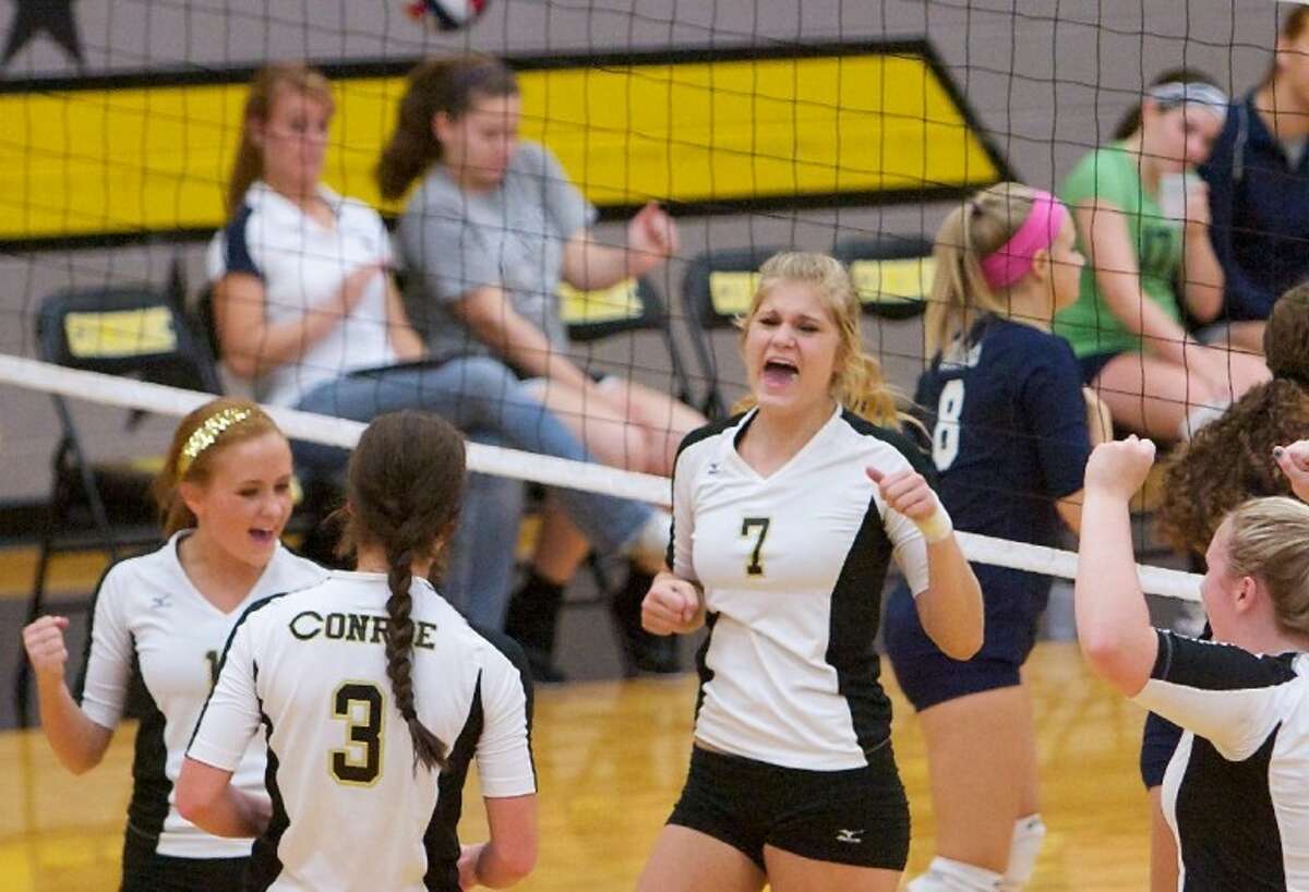 Conroe’s Jane Shute celebrates a point with teammates during Friday night’s non-district match against Tomball Memorial at Conroe High School. See more photos from this game online at www.yourconroenews.com/photos.