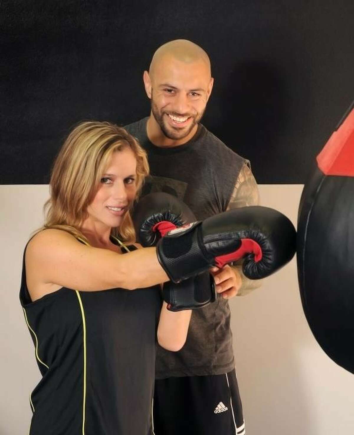 Dana “Balboa” Pritchard works out with Antonio Flores in preparation for her bout during the Fight for a Cause Sept. 8 to benefit 14 Montgomery County charities.