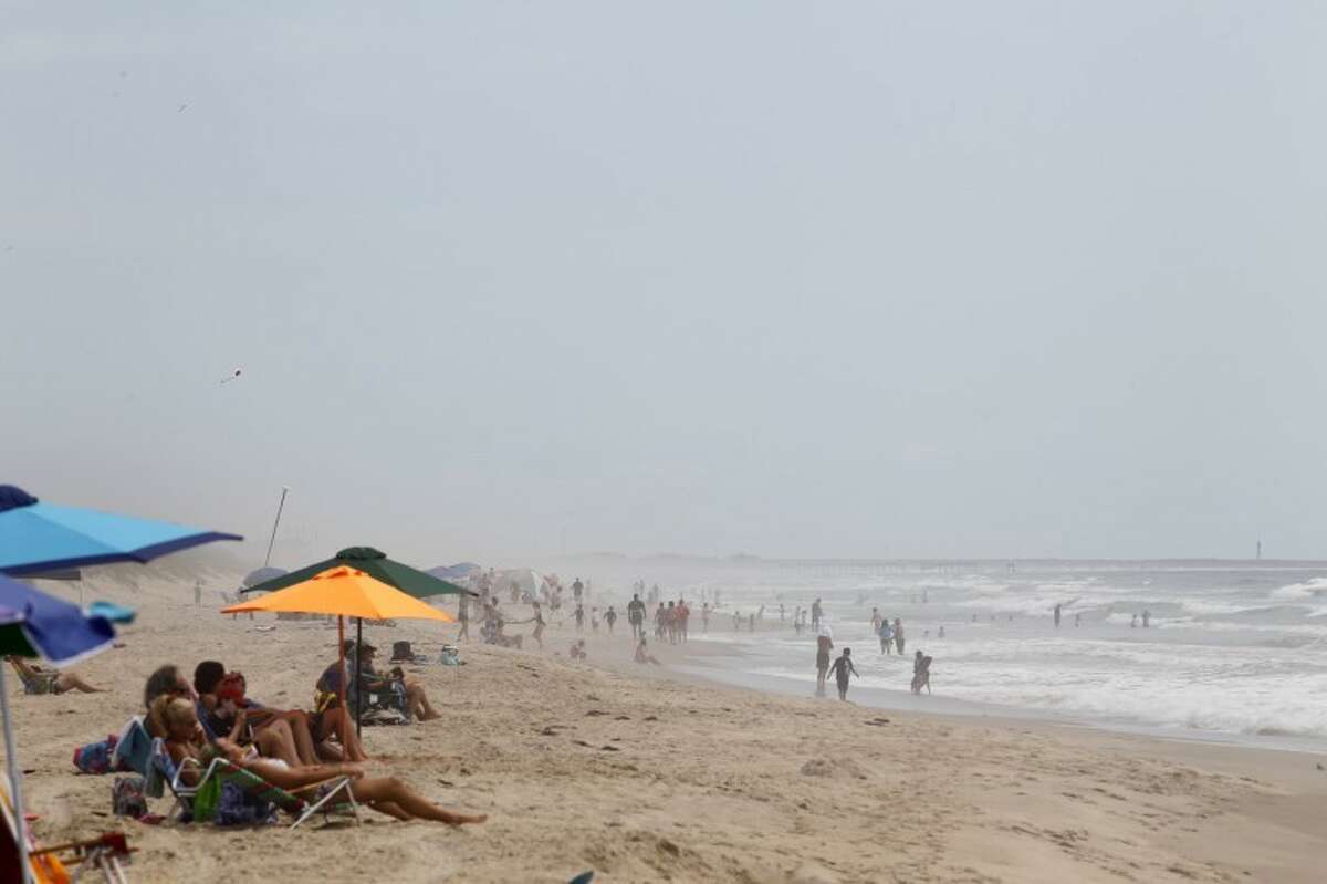 Beachgoers sunbathe at Cape Hatteras. N.C. on Wednesday, Aug. 24, 2011. Evacuations of tourists began on Ocracoke Island off North Carolina as Hurricane Irene strengthened to a major Category 3 storm over the Bahamas on Wednesday with the East Coast in its sights.