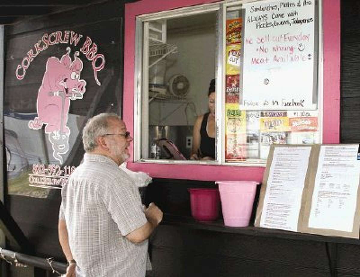 Whine & Dine co-founder Mark Hayter looks over the menu at Corkscrew BBQ -- one of the few truck restaurant operations in the county.