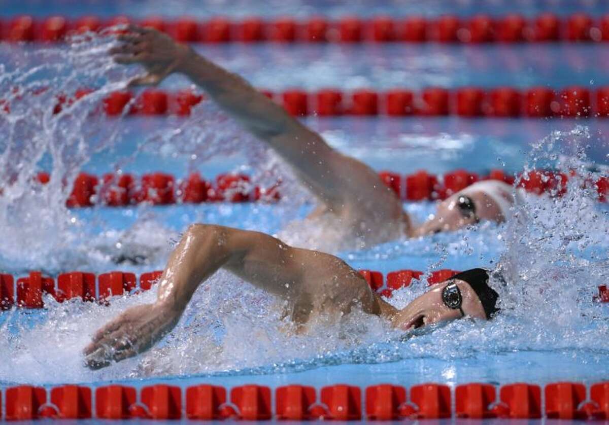 The Woodlands High School graduate Michael McBroom, bottom, and Canada’s Ryan Cochrane compete in a men’s 800-meter freestyle heat Tuesday at the FINA World Championships in Barcelona, Spain.