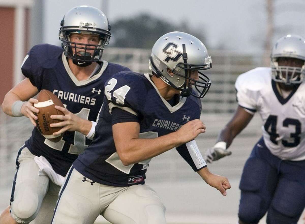 Shenandoah,TX - College Park Cavalier Varsity quarterback Zach Wright #11 rolls out for a pass early in the first quarter of thec College Park v Lamar Consolidated Football game at Woodforest Bank Stadium.