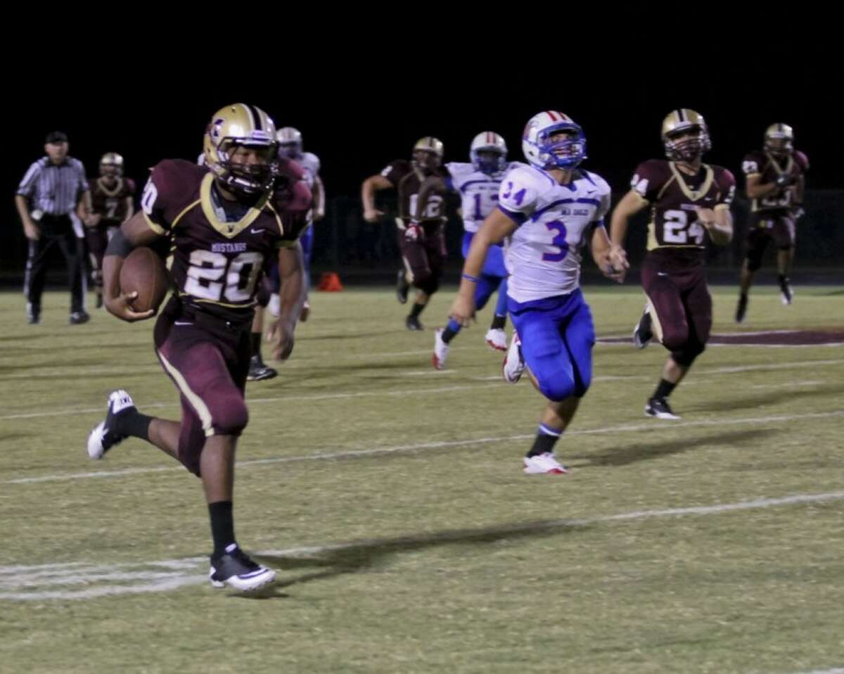 Magnolia West’s Desmond Richards runs for his second 80-yard touchdown during the Mustangs’ 46-12 home win over Oak Ridge on Friday.