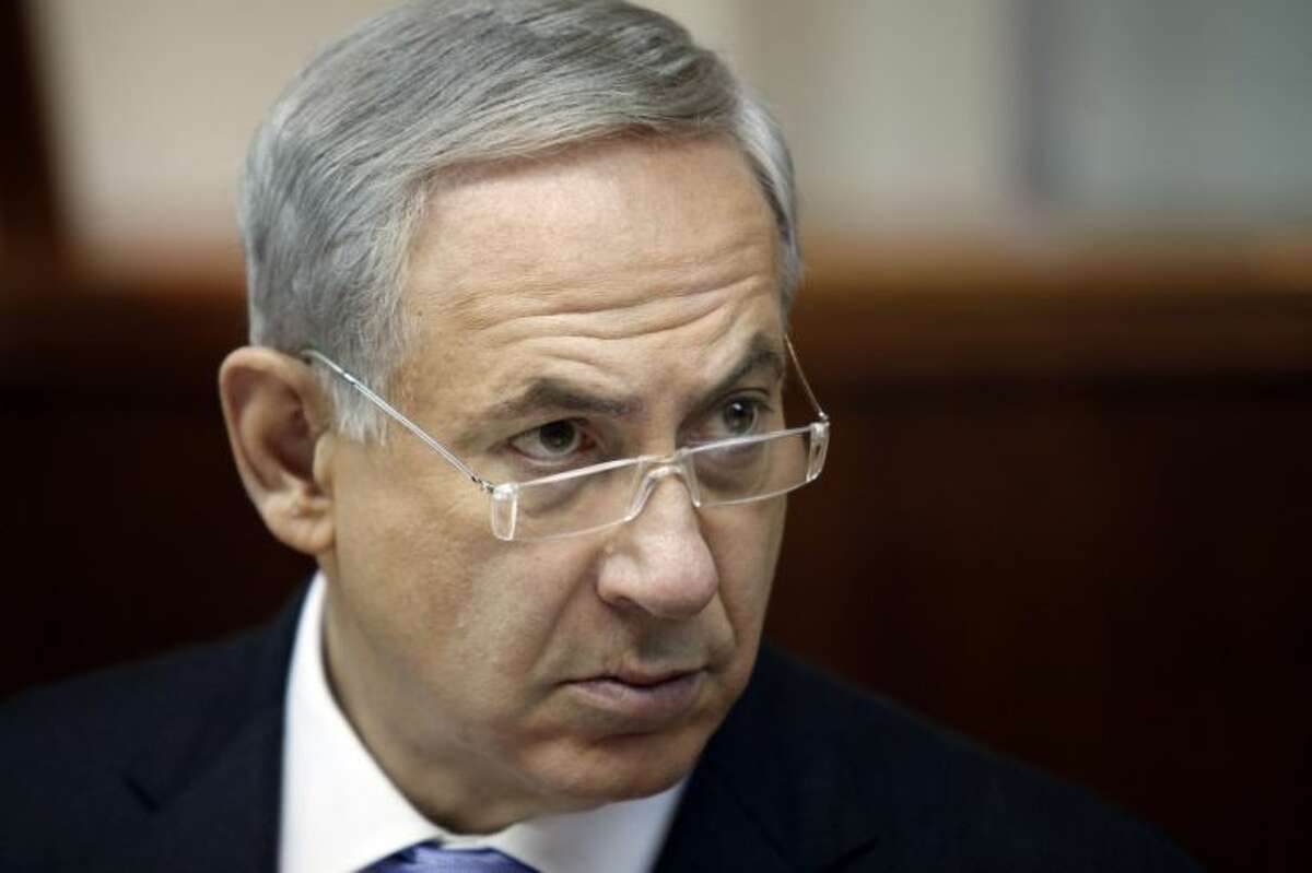 Israeli Prime Minister Benjamin Netanyahu listens during the weekly cabinet meeting in Jerusalem, Sunday, Aug. 4, 2013. Palestinian negotiator Saeb Erakat says that Israel will free the first batch of a promised 104 long-serving Palestinian and Israeli Arab prisoners on Aug. 13.