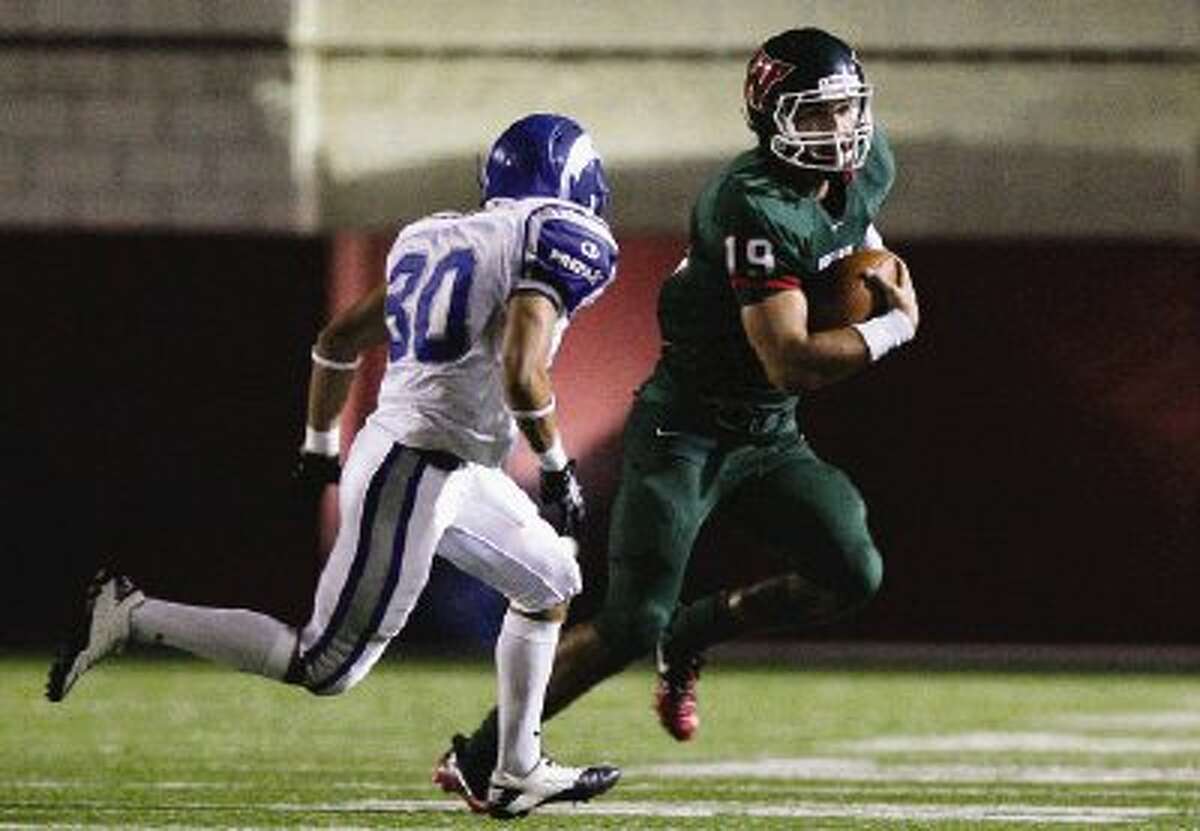 The Woodlands’ Jayme Taylor gains yards on the carry against Monterrey Tec’s Leopoldo Arellano during Thursday night’s season opening game at Woodforest Stadium in Shenandoah.