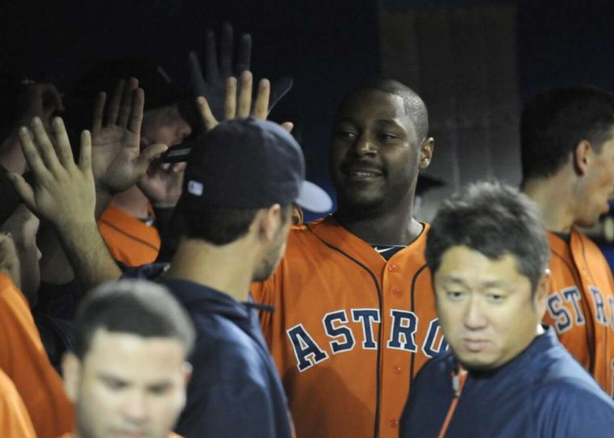 Houston Astros designated hitter Chris Carter high-fives teammates in the dugout after hitting a three-run home run in the first inning against the Toronto Blue Jays on Saturday in Toronto.