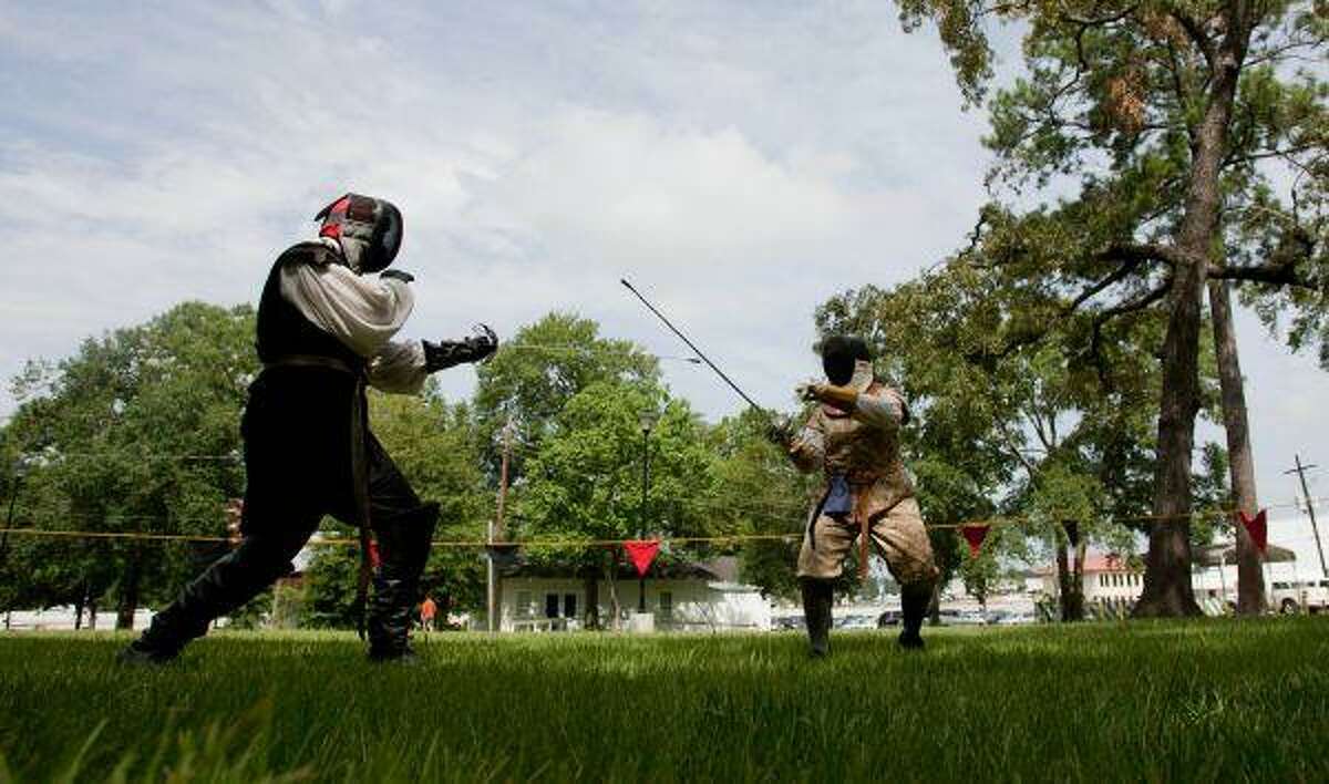LD Beers “Lemoine de Gascony” , left, and Amy Lee “Rosalia” of the Society for Creative Anachronism take part in “case” style rapier combat Saturday at Candy Cane Park in Conroe.