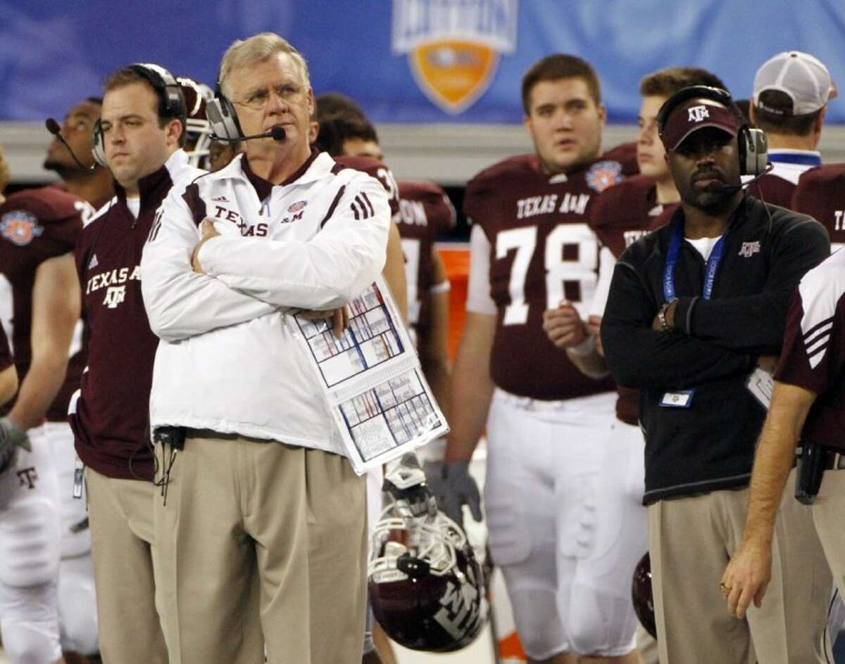 FILE - In this Jan. 7, 2011 file photo, Texas A&M head coach Mike Sherman, left looks on from the sideline during the second half of the Cotton Bowl NCAA college football game against LSU in Arlington.