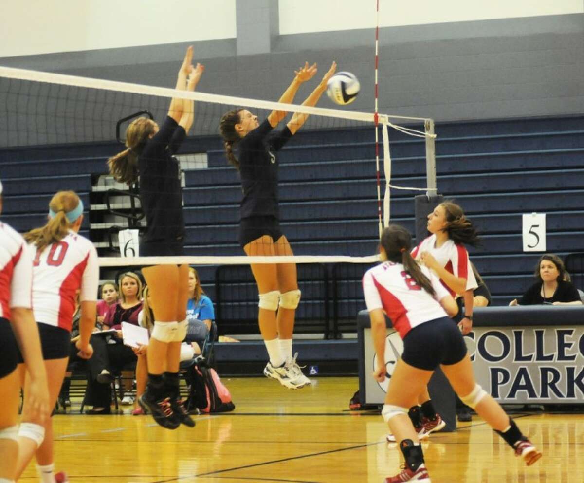 At left, College Park’s Emily Thorson and Haley Sobosle battle at the net against Atascocita Tuesday night.