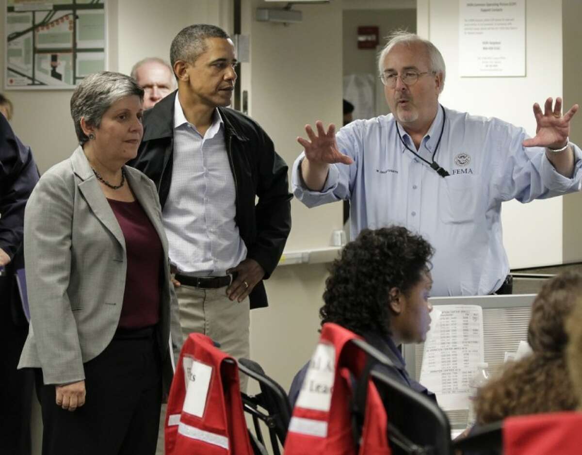 President Barack Obama listens to an update on the status of Hurricane Irene at Federal Emergency Management Agency (FEMA) headquarters in Washington Saturday. He is joined by Secretary of Homeland Security Janet Napolitano, left, and FEMA director Craig Fugate, right.