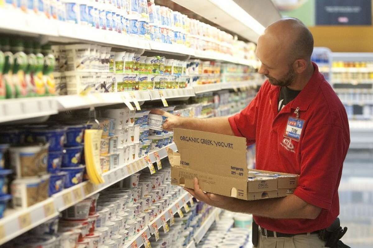 Tim Blanton stocks shelves with yogurt the day before the grand opening of the HEB North Woodlands Market on FM 1488 and Kuykendahl Road.