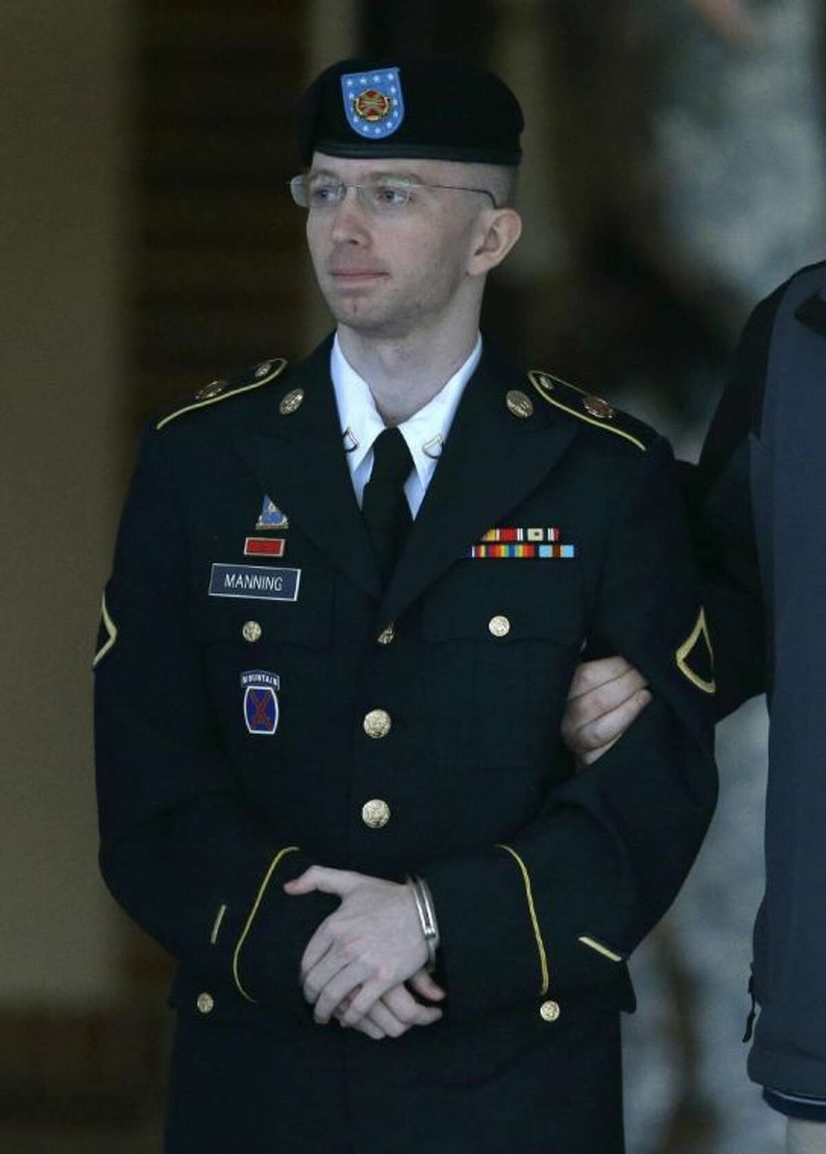 In this Monday, July 29, 2013 file photo, Army Pfc. Bradley Manning is escorted to a security vehicle outside of a courthouse in Fort Meade, Md. after the third day of deliberations in his court martial. US Army Pfc Bradley Manning was acquitted Tuesday, July 30, 2013 of aiding the enemy for giving secrets to WikiLeaks. Manning was convicted on espionage counts realted to the WikiLeaks case.