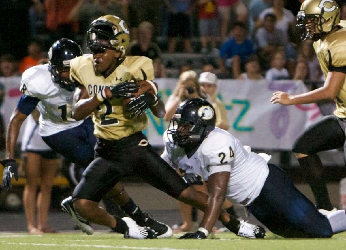 Nimitz’s Larry Bush tackles Conroe wide receiver Karl Smith during Friday night’s game at Buddy Moorhead Memorial Stadium.