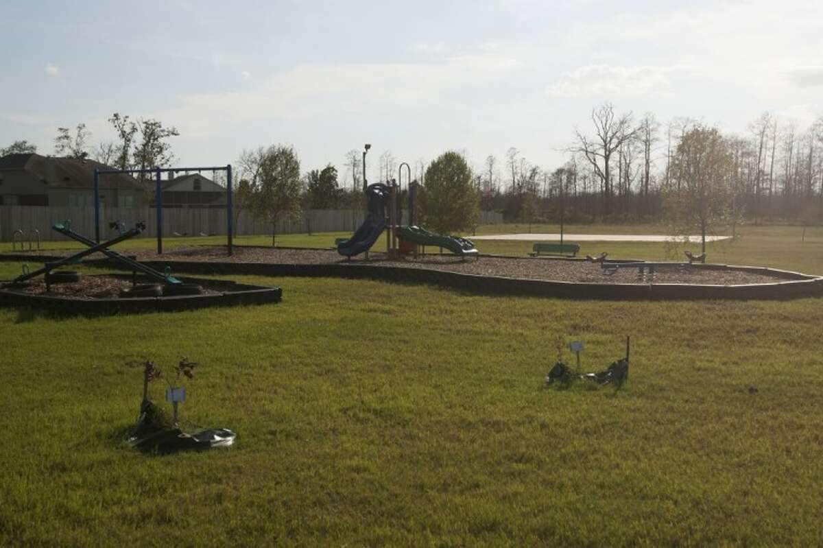 Main photo: A playground in the Ranch Crest subdivision in Magnolia was remodeled after it was damaged during last year’s wildfire. Inset photo: A park and playground sustains damage from a wildfire in the Ranch Crest subdivision of Magnolia on Sept. 7, 2011.