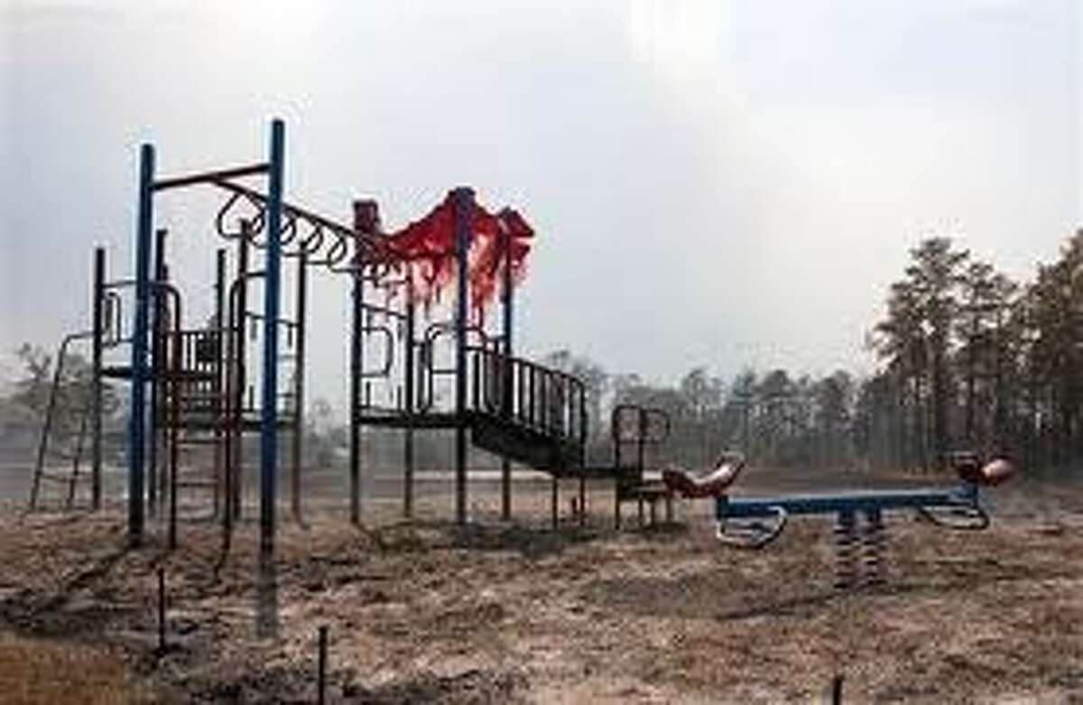 A park and playground sustains damage from a wildfire in the Ranch Crest subdivision of Magnolia on Sept. 7, 2011.