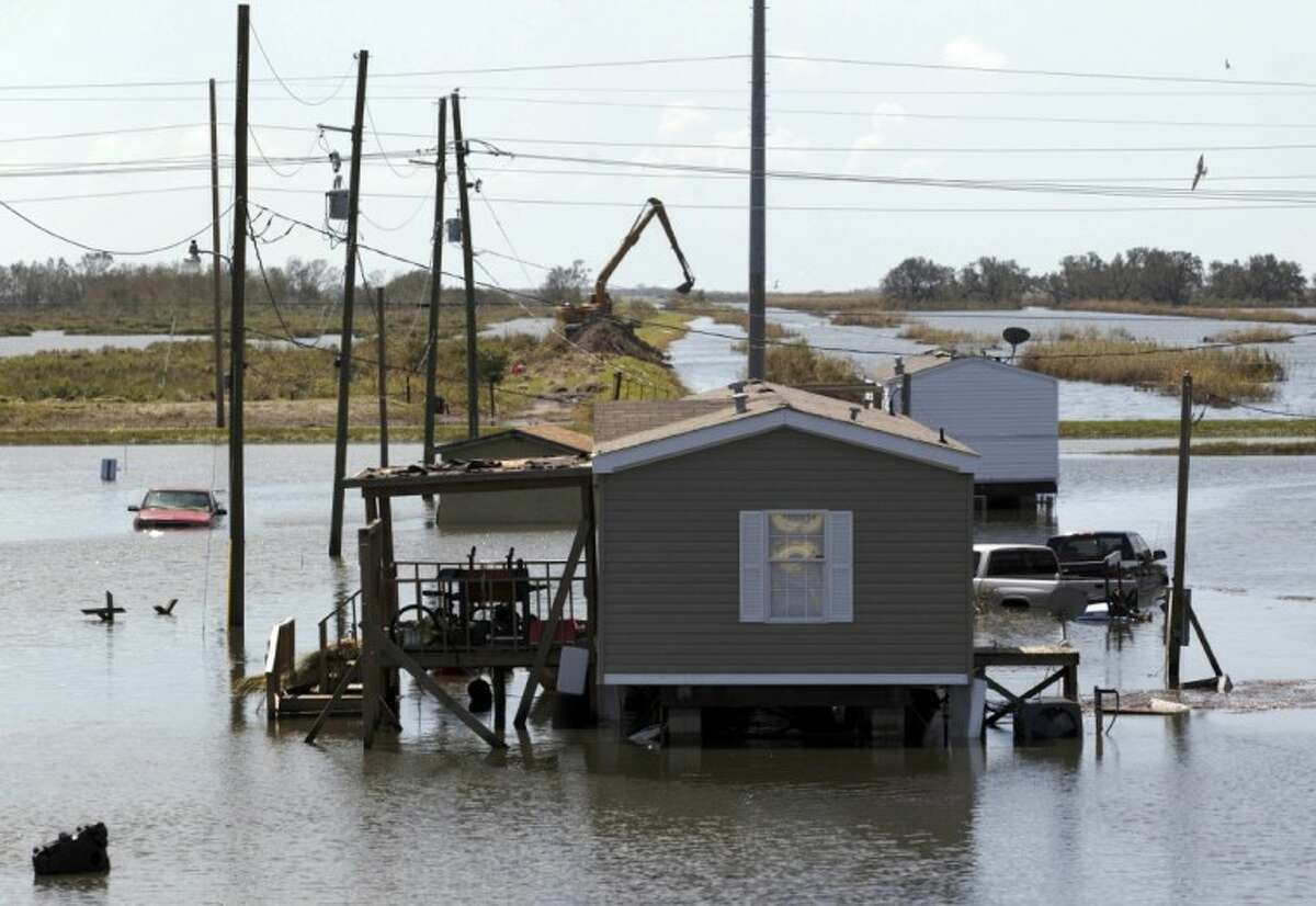 Trucks are flooded in receding waters from Hurricane Isaac along Louisiana Hwy 23 near West Point a La Hache, La., Monday.