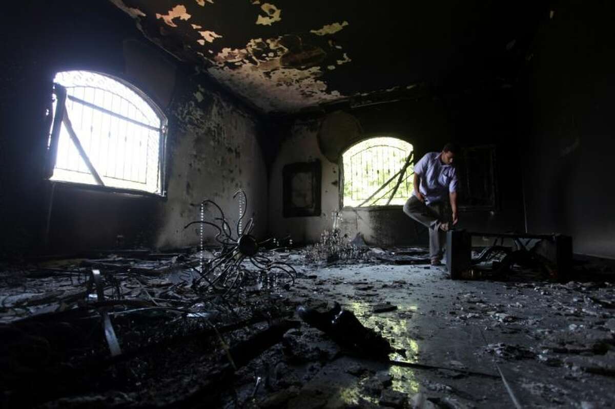 In this Sept. 13, 2012 file photo, a Libyan man investigates the inside of the U.S. Consulate after an attack that killed four Americans, including Ambassador Chris Stevens, on the night of Sept. 11, 2012, in Benghazi, Libya.