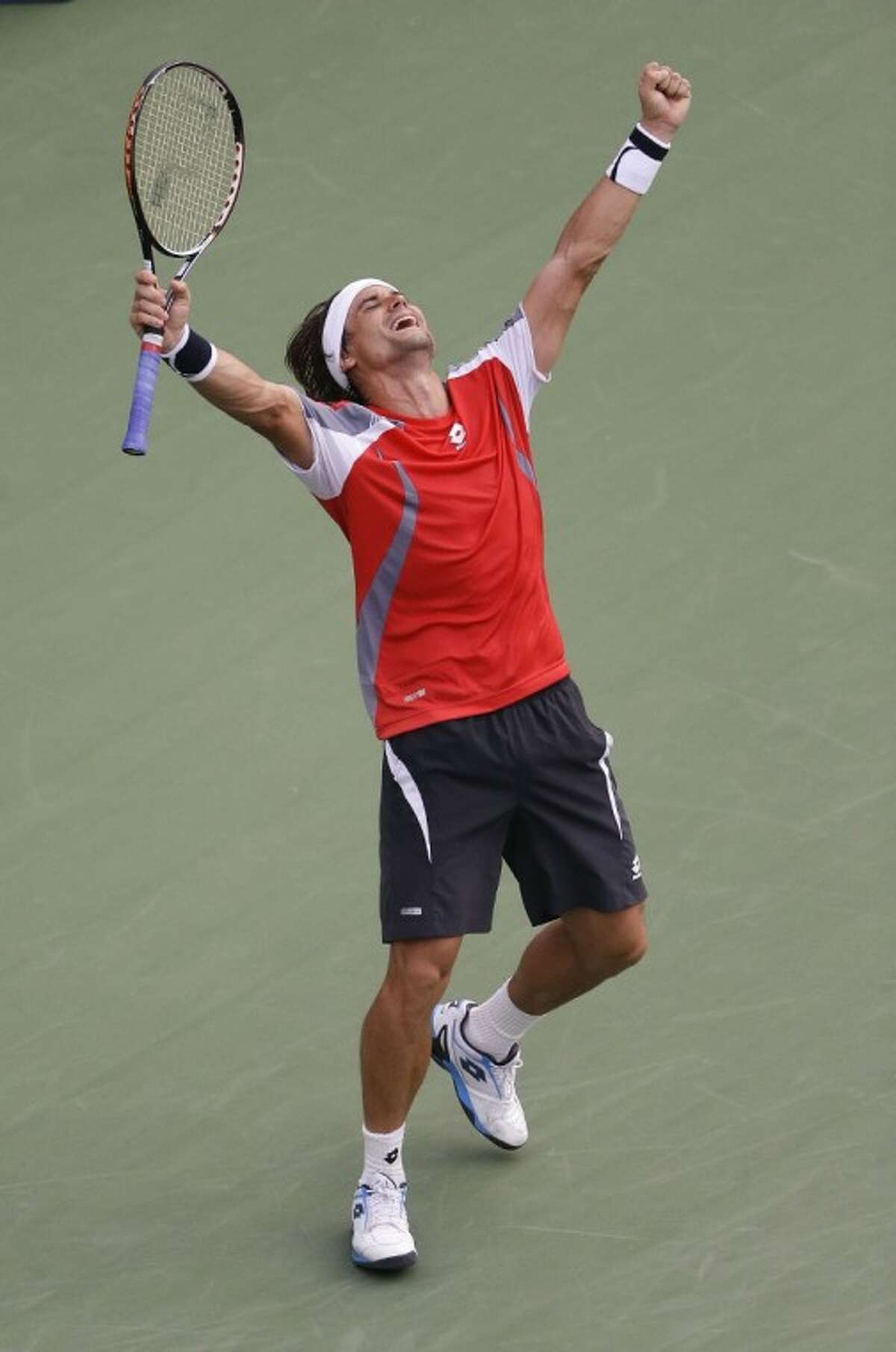 David Ferrer of Spain reacts after defeating Janko Tipsarevic in five sets in the U.S. Open.
