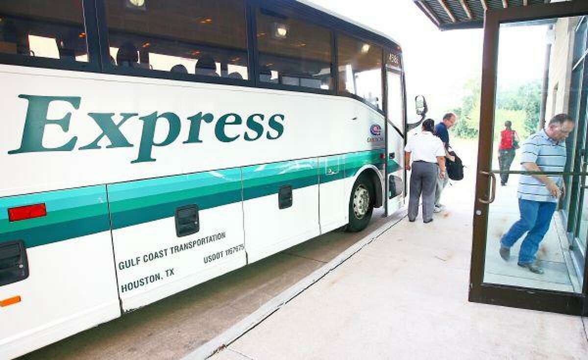 In this Courier file photo, commuters get off a bus from Houston at the Conroe Park and Ride located on Loop 336 West near Owen Road. The Brazos Transit District, which operates the Park and Ride, has said it is shutting down the Conroe operation July 31 because of a lack of funding.