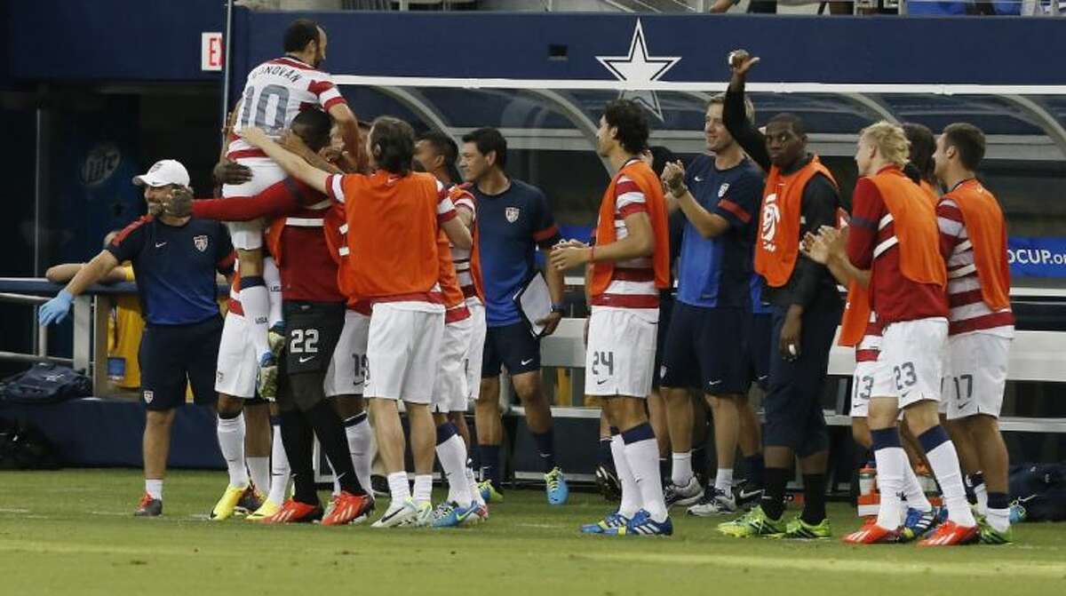 Teammates congratulate the United States’ Landon Donovan after he scored a goal against Honduras during the first half of the Gold Cup semifinals on Wednesday at Cowboys Stadium in Arlington.
